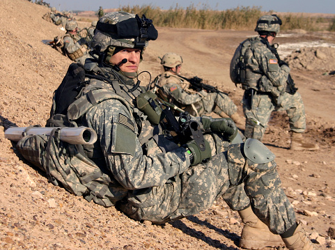 Soldiers in camouflage military uniforms carrying weapons, Reconnaissance missions in rugged mountains, Assault infantry battle training.