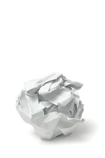 Single screwed or crumpled tissue paper or napkin in ball shape after use is isolated on white background with clipping path.