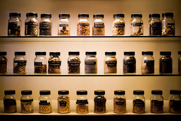 Shelves with labeled jars of exotic spices A selection of exotic spices, labelled and in jars. spice rack stock pictures, royalty-free photos & images