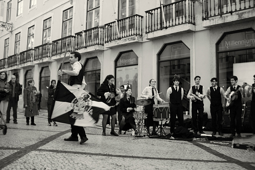 Lisbon, Portugal - December 17, 2022: A group of college students performs at the Rua Augusta street in Lisbon downtown.