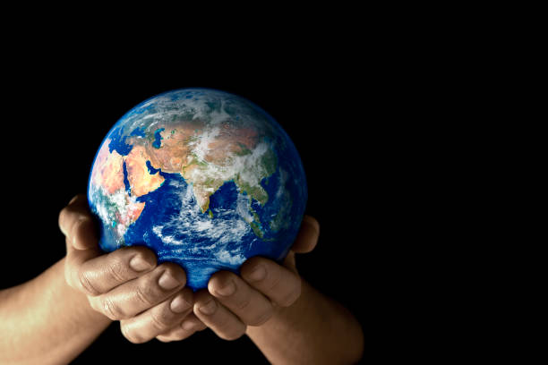 istock Hands holding the earth facing East on black background 157181701