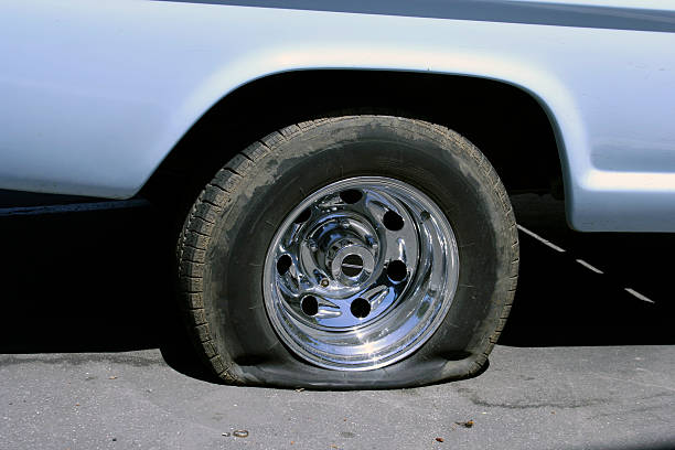 Very Flat Tire Car troubles - the start or end to a bad day... flat tire stock pictures, royalty-free photos & images