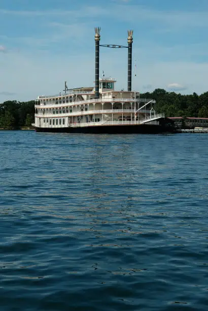 Vintage paddlewheel cruise boat with ample copy space in foreground