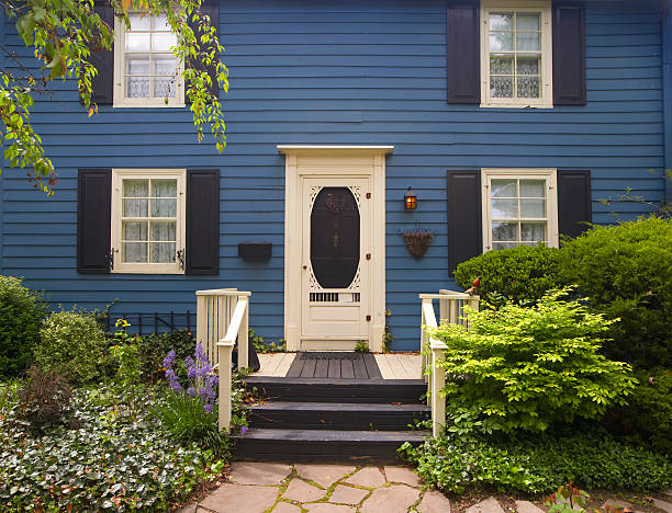 Deep Blue, two floors Traditional North American style residental houses on mature street with nice landscaping blue front door stock pictures, royalty-free photos & images