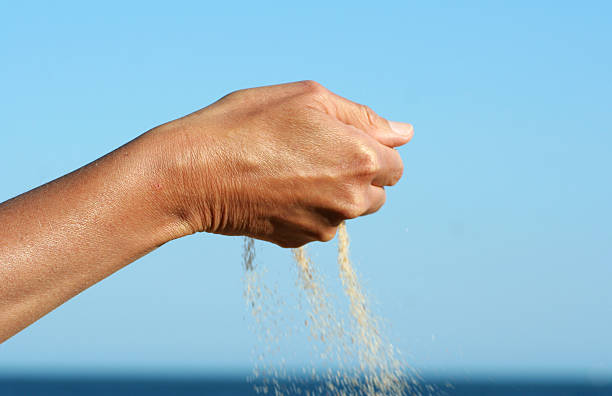 istock Sand running thru the fingers 157182280