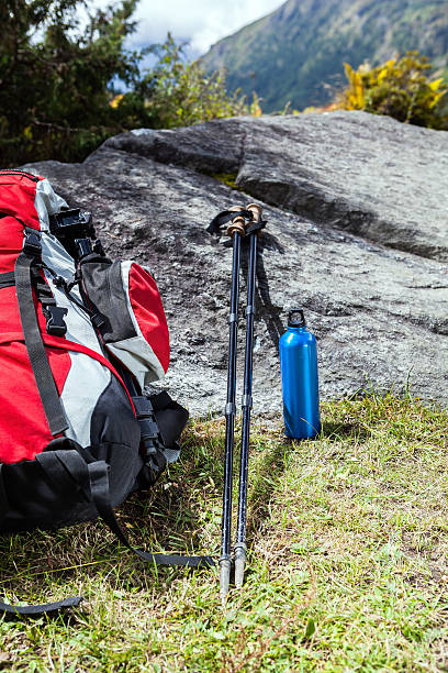 istock Trekking equipment in mountains, backpack, hiking sticks 157184656
