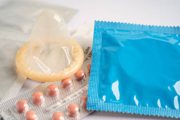 Birth control pills and condom, contraception health and medicine. Birth control pills and condom, contraception health and medicine. Ovulation stock pictures, royalty-free photos & images