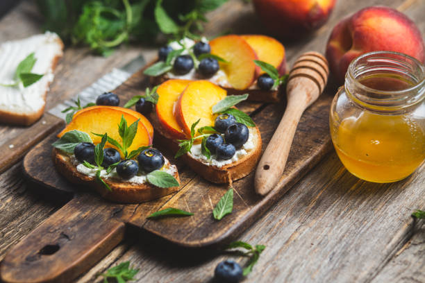 istock White bread sandwich with peaches, blueberries on a wooden board 1571853002