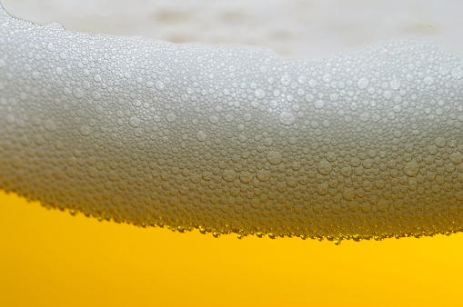 beer foam in glass with cold bubbles