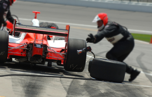 Tires are replaced rapidly on a pitstop during the race.
