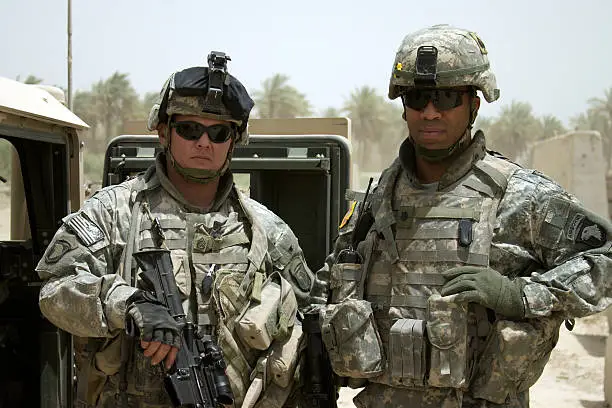A U.S. Staff Sergeant stands next to his Battalion Commander, a Lieutenant Colonel. 