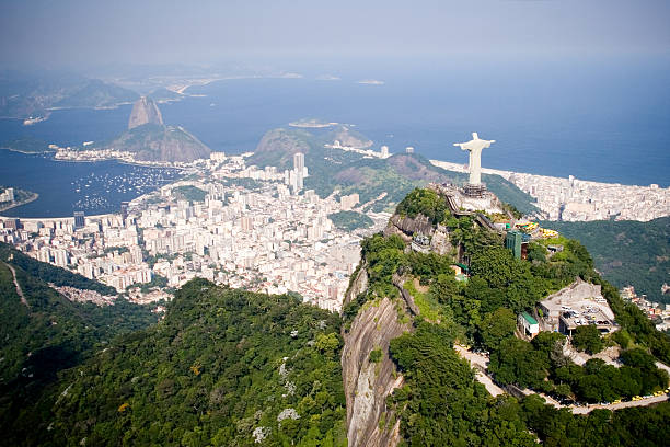 Aerial of Rio de Janeiro Aerial view of Rio de Janeiro on a sunny day taken from a helicopter.  In view are the landmarks Christ the Redeemer and Sugarloaf Mountain. rio de janeiro stock pictures, royalty-free photos & images