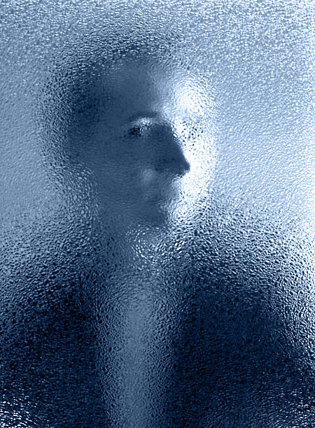 istock Eerie Face Peering Through Frosted Glass 157185622