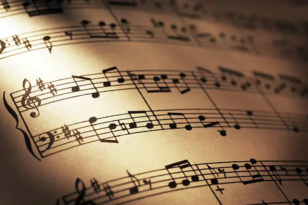 Close-up shot of sheet music in sepia tone.