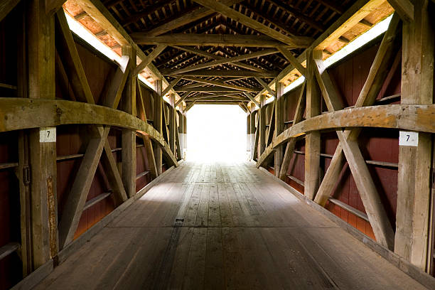 istock Covered bridge in Amish county towards the light 157185635