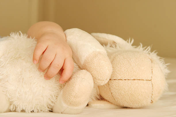 istock baby hand and a toy 157185643