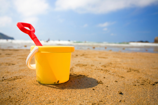 A bucket and spade on a beach