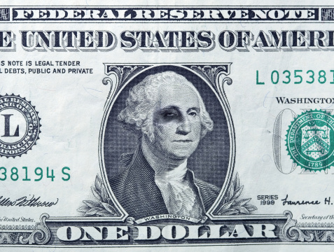 US economy downfall concept. Macro shot of Dollar bill - George Washington has black eye.