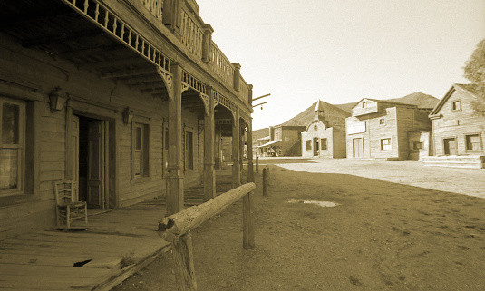 Wild West, old wooden buildings, houses, sepia toned.