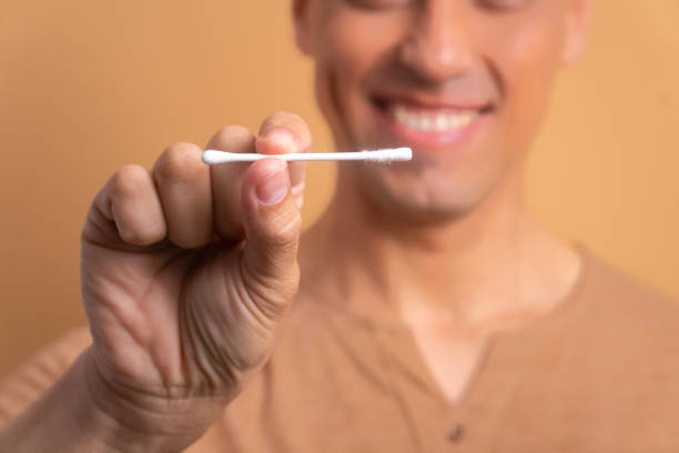 istock hands man showing paper and cotton swab 1571861630