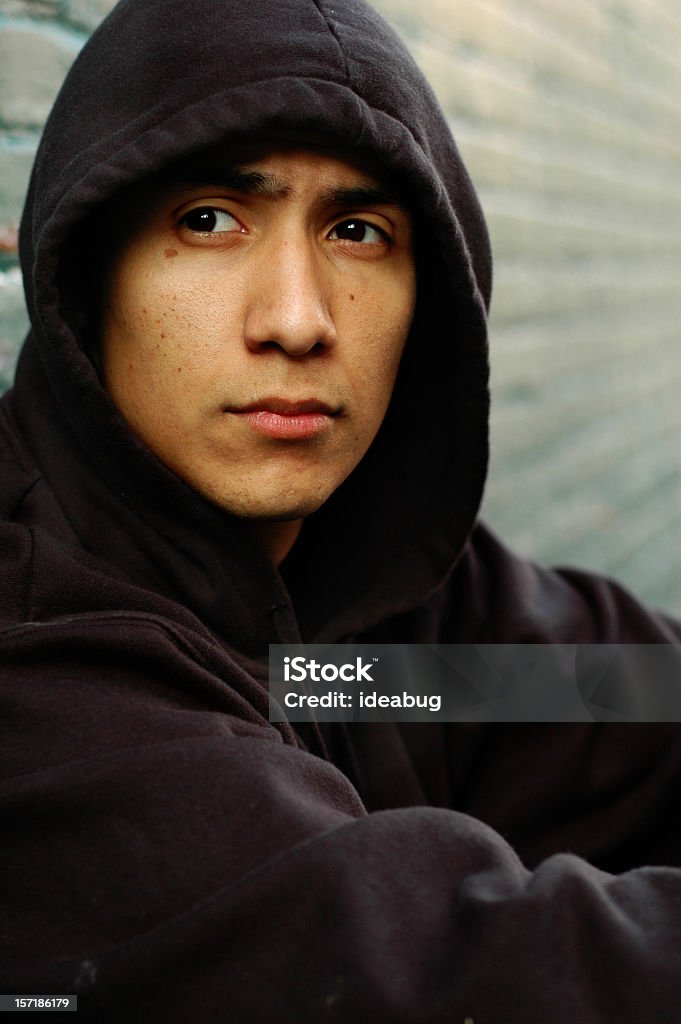 Worried Young, hispanic man worried about the future of his life on the street as a gangster. Homelessness Stock Photo