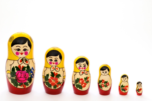 Russian Matryoshka Dolls in different sizes. Traditional Matryoshka set in a row. Set of wooden toys on white background.