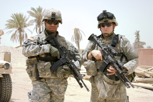 A U.S. Sergeant stands next to his Battalion Commander, a Lieutenant Colonel. 