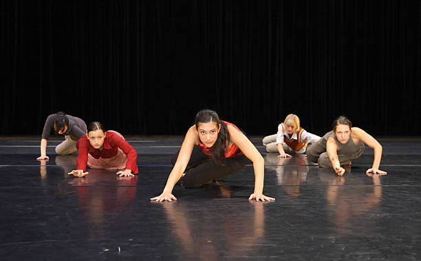 istock Group of contemporary dancers performing on stage 157186578
