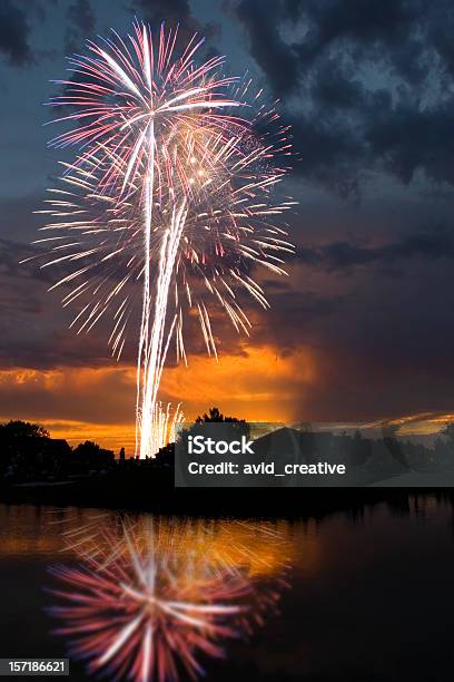 Photo libre de droit de Feux Dartifice Au Coucher Du Soleil Reflète Dans Un Lac banque d'images et plus d'images libres de droit de Feu d'artifice