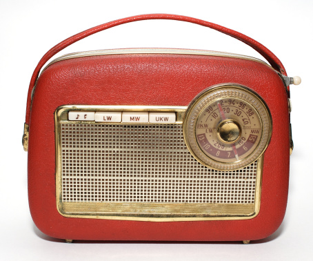 Front view of old retro radio on wood table with wooden wall, background