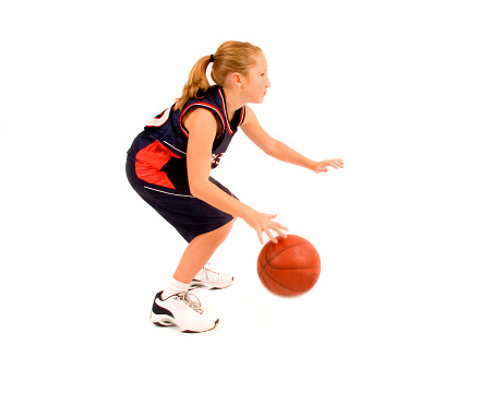 Mature women playing basketball