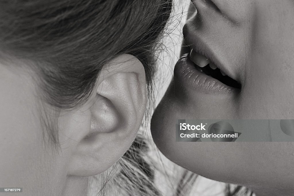 telling secrerts girls whispering close up of mouth and ear Gossip Stock Photo