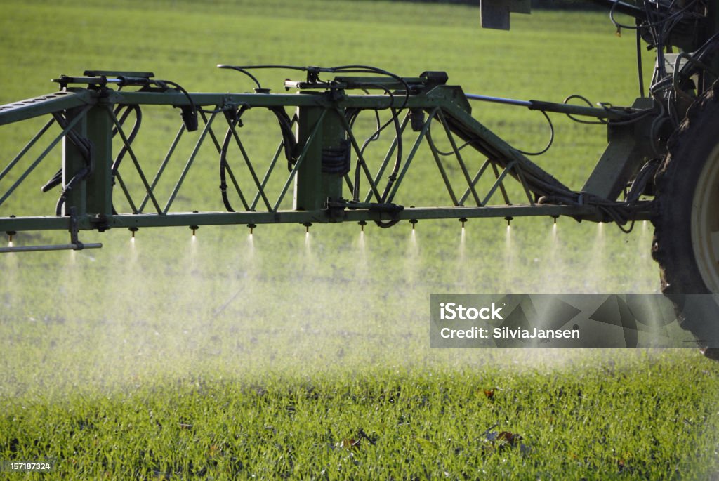 spraying on field detail of tractor sprayer, spraying fertilizer on a field Crop Sprayer Stock Photo