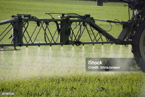 Spraying On Field Stock Photo - Download Image Now - Crop Sprayer, Spraying, Agricultural Field