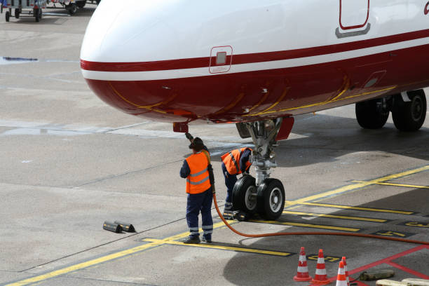 istock ground crew working below the cockpit of a passenger jet 157187428