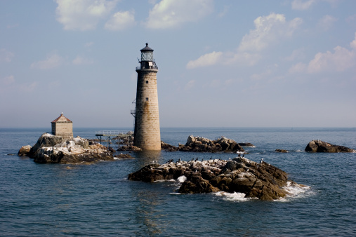 Armenistis Lighthouse at NW part of Mykonos island, Cyclades, Greece in afternoon.