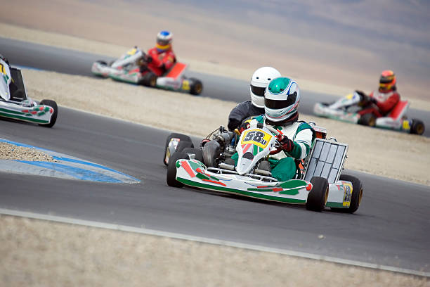 Go-kart racing Several modern high speed shifter karts compete at over 100mph on a raceway. motorsport photos stock pictures, royalty-free photos & images