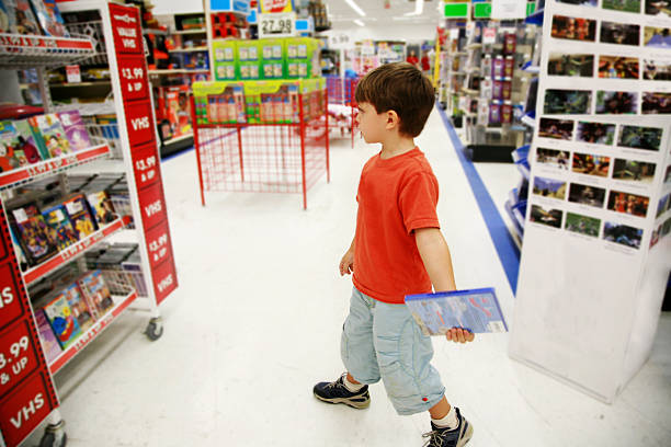 Little Shopper in Toy Store Boy in a toy store. toy store stock pictures, royalty-free photos & images