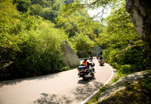 Motorcycles navigating a narrow mountain road in Vermont.