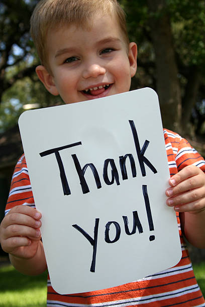 istock Thank you Sign Held By Happy Young Boy 157187594