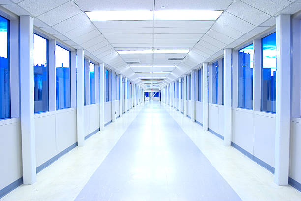 An empty white hall with blue windows stock photo