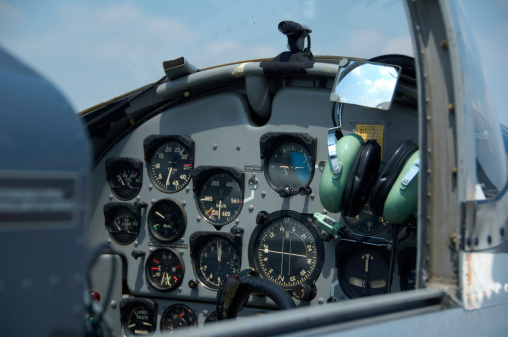 Flight instrumentation in the cockpit of a small plane in the air.  All required instrumentation, plus a GPS and radios are shown in the picture.