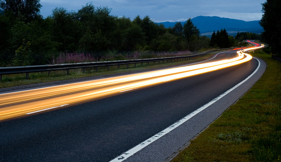 Evening traffic on the A9 road in the Highlands of Scotland.