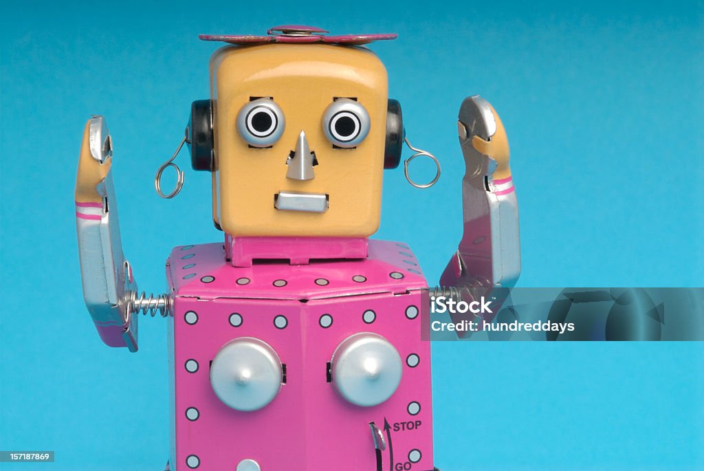 Pink female robot with arms raised Female Robot holding arms up in the air Robot Stock Photo