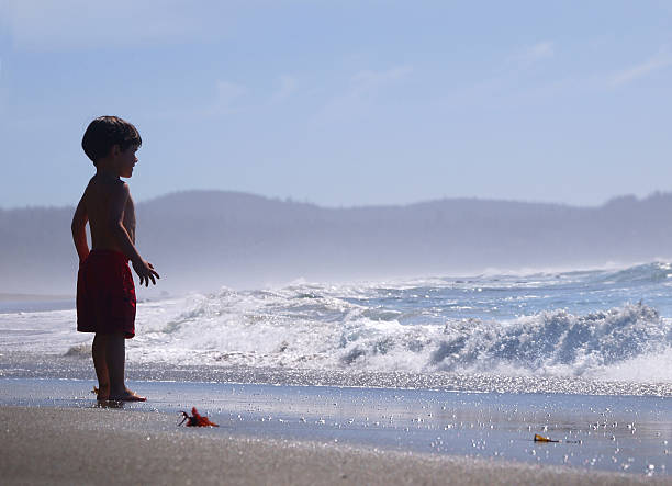 Kid Watching the Ocean stock photo