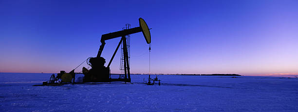 Winter Panoramic Oil Pumpjack banner Panoramic of a pumpjack in the winter with snow oil pump oil industry alberta equipment stock pictures, royalty-free photos & images