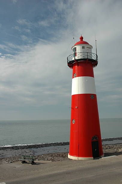 Red lighthouse isolated on white background with reflection effect. See also: