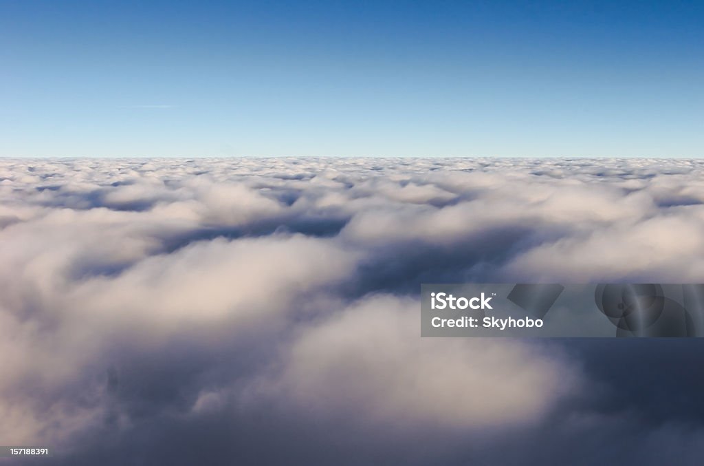 Above the Clouds Early morning flight above a cloud layer Aerial View Stock Photo