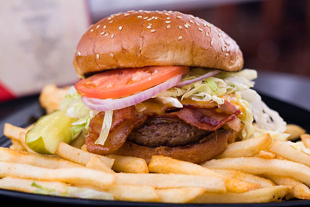 istock Cheese and bacon burger with gherkin and fries 157188536