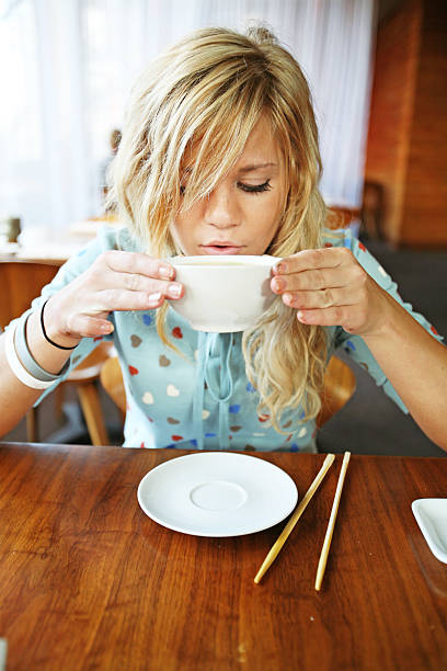 istock Young Blonde Cooling her Soup Down 157188634
